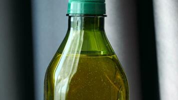 olive oil bottle on table against gray color background video