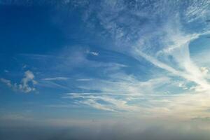 Most Beautiful and Best High Angle Dramatical Colourful Sky Footage from Above The Clouds. The Fast Moving Clouds During Sun rising Early in the Morning over Luton City of England UK photo