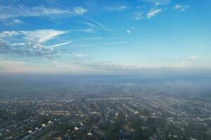 Most Beautiful and Best High Angle Dramatical Colourful Sky Footage from Above The Clouds. The Fast Moving Clouds During Sun rising Early in the Morning over Luton City of England UK photo