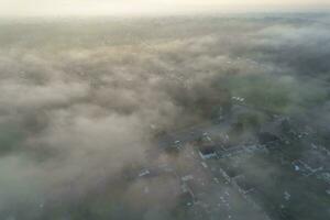 Most Beautiful and Best High Angle Dramatical Colourful Sky Footage from Above The Clouds. The Fast Moving Clouds During Sun rising Early in the Morning over Luton City of England UK photo