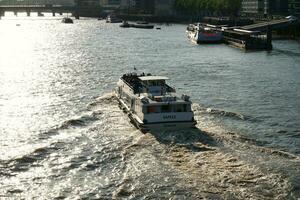 Best View of Boat over River Thames Waters at London Bridge, Capital City of England Great Britain. The Image Was Captured June 4th, 2023 photo