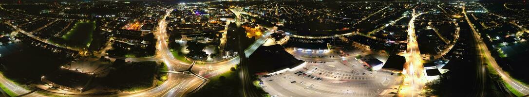 Ultra Wide Aerial Panoramic View of Illuminated Downtown Buildings, Roads and Central Luton City of England UK at Beginning of Clear Weather's Night of September 5th, 2023 photo