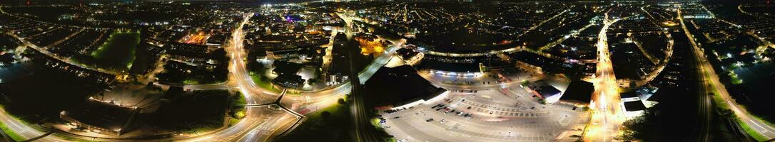 Ultra Wide Aerial Panoramic View of Illuminated Downtown Buildings, Roads and Central Luton City of England UK at Beginning of Clear Weather's Night of September 5th, 2023 photo