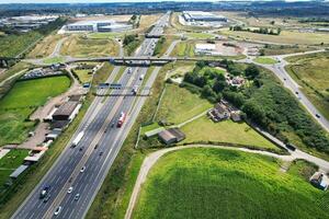 High Angle View of British Motorways and Highways and Traffic on M1 Junction 11a of Luton and Dunstable England UK. Image Was Captured on August 15th, 2023 photo