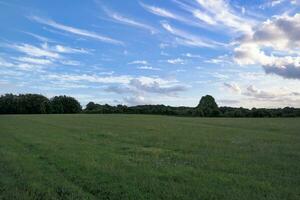 High Angle Panoramic Landscape View of British Agricultural Farms at Countryside Landscape of Sharpenhoe Clappers, Luton City of England UK. Footage Captured on August 19th, 2023 photo