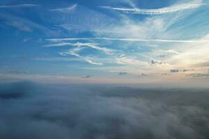 Most Beautiful and Best High Angle Dramatical Colourful Sky Footage from Above The Clouds. The Fast Moving Clouds During Sun rising Early in the Morning over Luton City of England UK photo