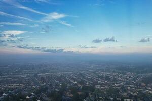 Most Beautiful and Best High Angle Dramatical Colourful Sky Footage from Above The Clouds. The Fast Moving Clouds During Sun rising Early in the Morning over Luton City of England UK photo