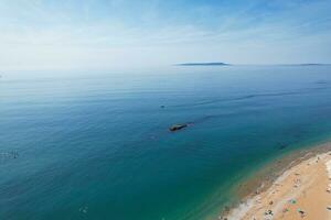 Best Aerial Footage of People are Enjoying Boat Ride at Gorgeous British Tourist Attraction and Ocean Sea View of Durdle Door Beach of England UK. Captured with Drone's Camera on September 9th, 2023 photo