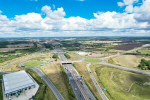 High Angle View of British Motorways and Highways and Traffic on M1 Junction 11a of Luton and Dunstable England UK. Image Was Captured on August 15th, 2023 photo