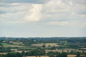 High Angle Panoramic Landscape View of British Agricultural Farms at Countryside Landscape of Sharpenhoe Clappers, Luton City of England UK. Footage Captured on August 19th, 2023 photo