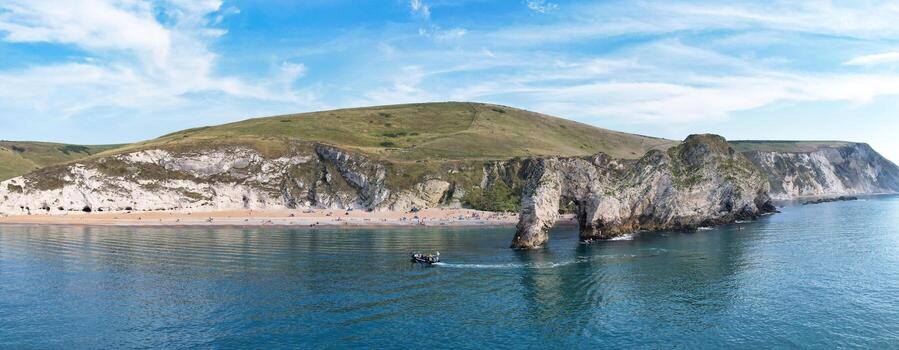 Most Beautiful High Angle View of British Landscape and Sea View of Durdle Door Beach of England Great Britain, UK. Image Was captured with Drone's camera on September 9th, 2023 photo