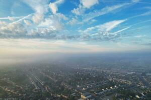 Most Beautiful and Best High Angle Dramatical Colourful Sky Footage from Above The Clouds. The Fast Moving Clouds During Sun rising Early in the Morning over Luton City of England UK photo