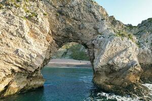 Most Beautiful Landscape and Sea View of Durdle Door Beach of England Great Britain, UK. Image Was captured with Drone's camera on September 9th, 2023 photo