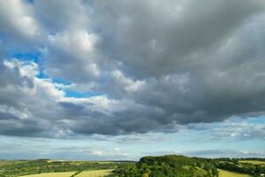 Most Beautiful High Angle view of Dramatical Sky and Clouds over British Countryside Landscape During Sunset photo
