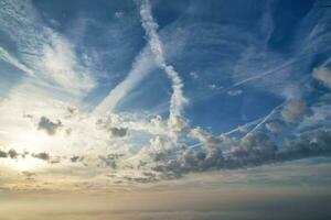 Most Beautiful and Best High Angle Dramatical Colourful Sky Footage from Above The Clouds. The Fast Moving Clouds During Sun rising Early in the Morning over Luton City of England UK photo