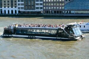 Best View of Boat over River Thames Waters at London Bridge, Capital City of England Great Britain. The Image Was Captured June 4th, 2023 photo