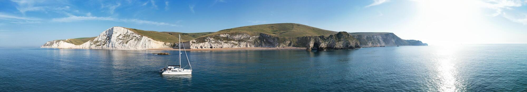 People at Most Beautiful High Angle View of British Landscape and Sea View of Durdle Door Beach of England Great Britain, UK. Image Was captured with Drone's camera on September 9th, 2023 photo