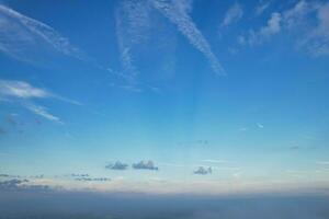 Most Beautiful and Best High Angle Dramatical Colourful Sky Footage from Above The Clouds. The Fast Moving Clouds During Sun rising Early in the Morning over Luton City of England UK photo