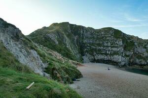 Best Aerial Footage of People are Enjoying Boat Ride at Gorgeous British Tourist Attraction and Ocean Sea View of Durdle Door Beach of England UK. Captured with Drone's Camera on September 9th, 2023 photo