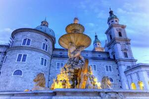 Fountain and cathedral at the Residenzplatz in Salzburg, Austria photo