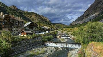río otoño a cervières aldea, Alpes montañas, Francia foto