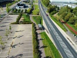 High Angle Footage of British Road and Traffic at Caldecotte Lake of Milton Keynes City of England Great Britain, Beautiful View Captured on August 21st, 2023 with Drone's Camera During Sunny Day photo