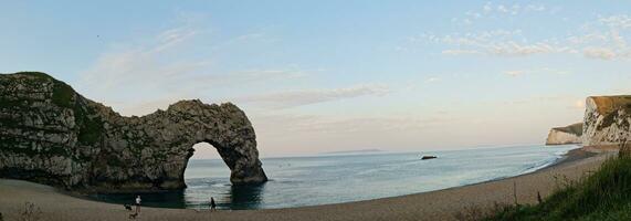 Most Beautiful High Angle View of British Landscape and Sea View of Durdle Door Beach of England Great Britain, UK. Image Was captured with Drone's camera on September 9th, 2023 photo