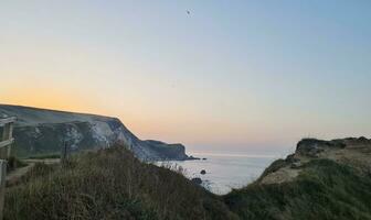 Best Aerial Footage of Gorgeous British Tourist Attraction and Ocean Sea View of Durdle Door Beach of England UK. Captured with Drone's Camera on September 9th, 2023 photo