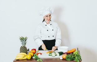 Portrait of female chef cutting vegetables, Female chef preparing salad, a female chef cutting fresh vegetables, Concept of a female chef preparing fresh vegetables photo