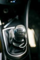 Gear lever of a vehicle. Close-up of a car gear lever, Close up of a car gear knob. Detail view of a vehicle transmission lever photo