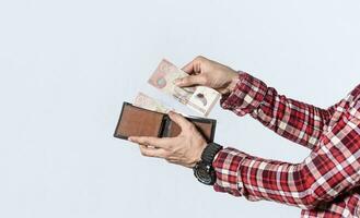 Man taking money out of his wallet, close up of hands taking money out of his wallet isolated, Nicaraguan banknotes, cash payment concept photo