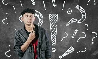 Thoughtful people looking up with exclamation marks, Thoughtful man with exclamation marks on isolated background, Indecisive people looking up , Concept of man asking with exclamation marks photo