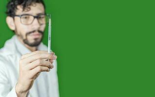 Close-up of a doctor's hand holding a syringe, Close-up of a hand holding an injection on an isolated background, Doctor and syringe concept photo