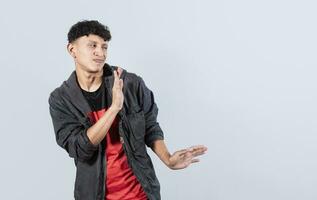 Disgusted man with rejection gesture, pulls palms in rejection, displeased guy rejecting something photo