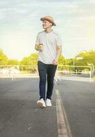 Happy man walking with glass of coffee, happy young man walking with glass of coffee photo