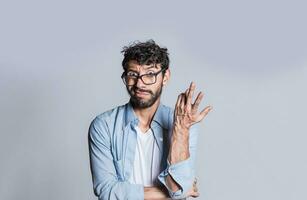 Puzzled man gesturing with one hand, Person with puzzled face frowning, Close up of puzzled people gesturing with hands. photo