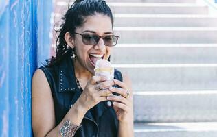 Urban girl eating an ice cream cone, A girl eating an ice cream outdoors, girl enjoying an ice cream, close up of a woman holding an ice cream photo