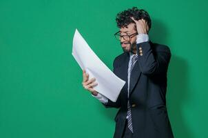 Confused businessman with documents in hand, Businessman puzzled with documents in hand isolated, Concept of man in formal suit frustrated with documents in hand photo