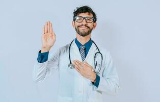 Doctor raising hand and swearing. handsome doctor making oath and promise isolated photo