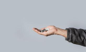 Hands with several coins in isolated background, Close up of hand with several coins, currency savings concept photo