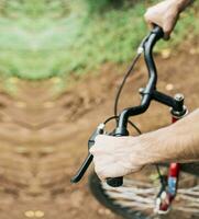 high angle of hands on bicycle handlebars, Side view of hands on bicycle handlebars. Concept of cyclist's hands on the handlebars photo