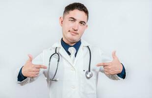 Cheerful doctor pointing at himself isolated. Satisfied young doctor pointing at himself on isolated background photo