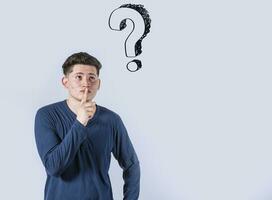 Thoughtful young man looking up with exclamation marks, Thoughtful man with exclamation marks on isolated background, Indecisive man looking up , Concept of man asking with exclamation marks photo