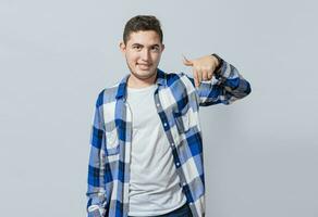 sonriente chico señalando abajo con uno mano aislado, concepto de joven hombre recomendando un producto aislado. sonriente latín chico señalando con un mano abajo, asombrado joven hombre señalando abajo foto