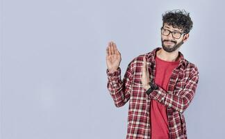 Displeased intense man with rejection gesture, pulls palms in rejection, frowns in disgust. Displeased person rejecting with rejection gesture, throw palms isolated photo