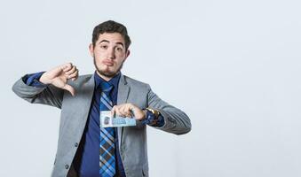 Business man holding banknote with thumb disapproving, man with money in hand and thumb down photo