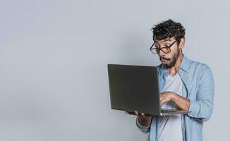 Surprised person looking at an offer on laptop, surprised people looking at a promotion on laptop isolated. Amazed handsome man with laptop isolated. photo