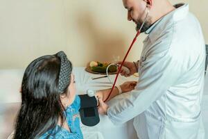 Nutritionist measuring blood pressure to patient. Measuring blood pressure to patient in the office, Nutritionist man measuring blood pressure to female patient in office photo