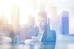 Business Girl Standing In A Modern Building Near The Window With Phone photo