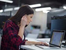 female software developer using laptop computer photo